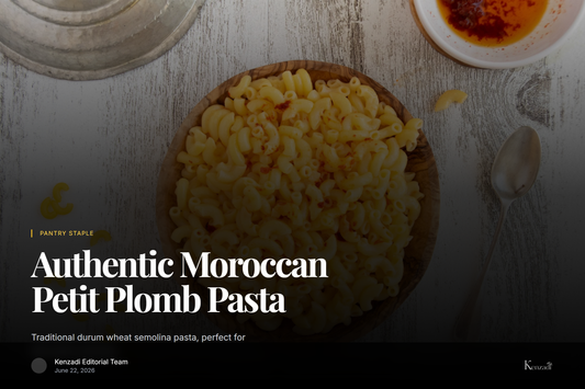 A close-up of golden Moroccan Petit Plomb pasta in a wooden bowl, with a spoonful held above it,