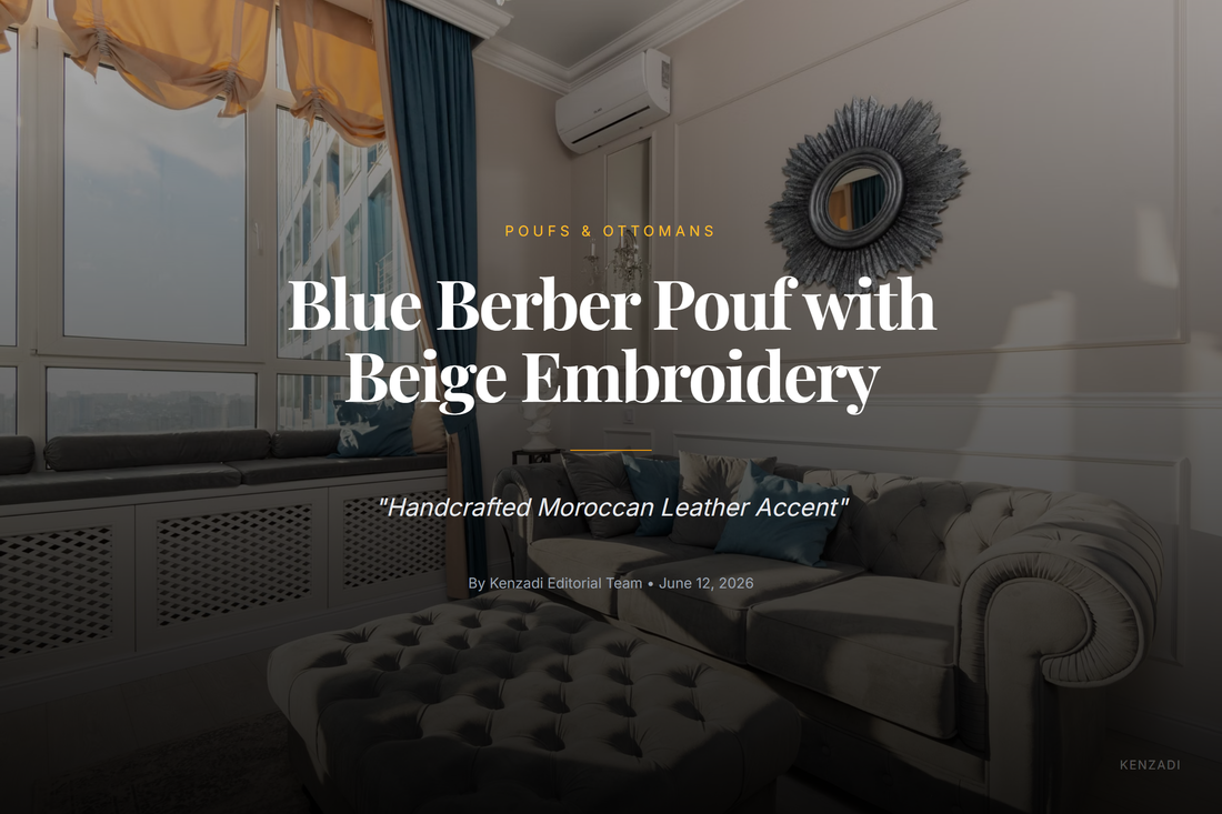 Round blue Moroccan leather pouf with hand-stitched beige embroidery sitting on a woven rug in a bright living