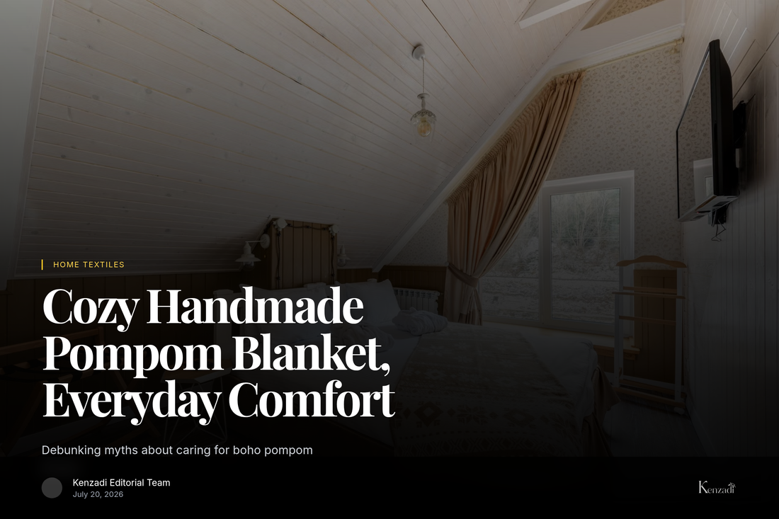 White handmade pompom blanket draped over a king-size bed cover