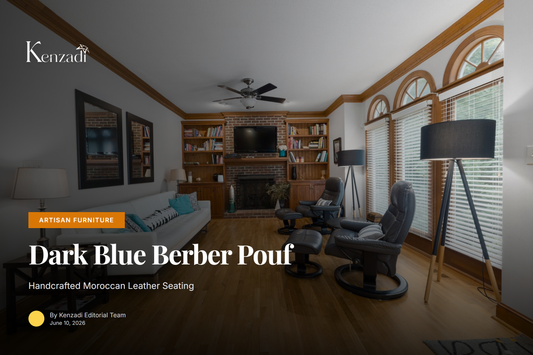 Round dark blue Moroccan leather pouf with blue Berber embroidery displayed in minimalist living room setting