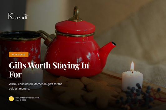 A wooden tray with a bottle of Moroccan olive oil, a glass of mint tea, and warm winter