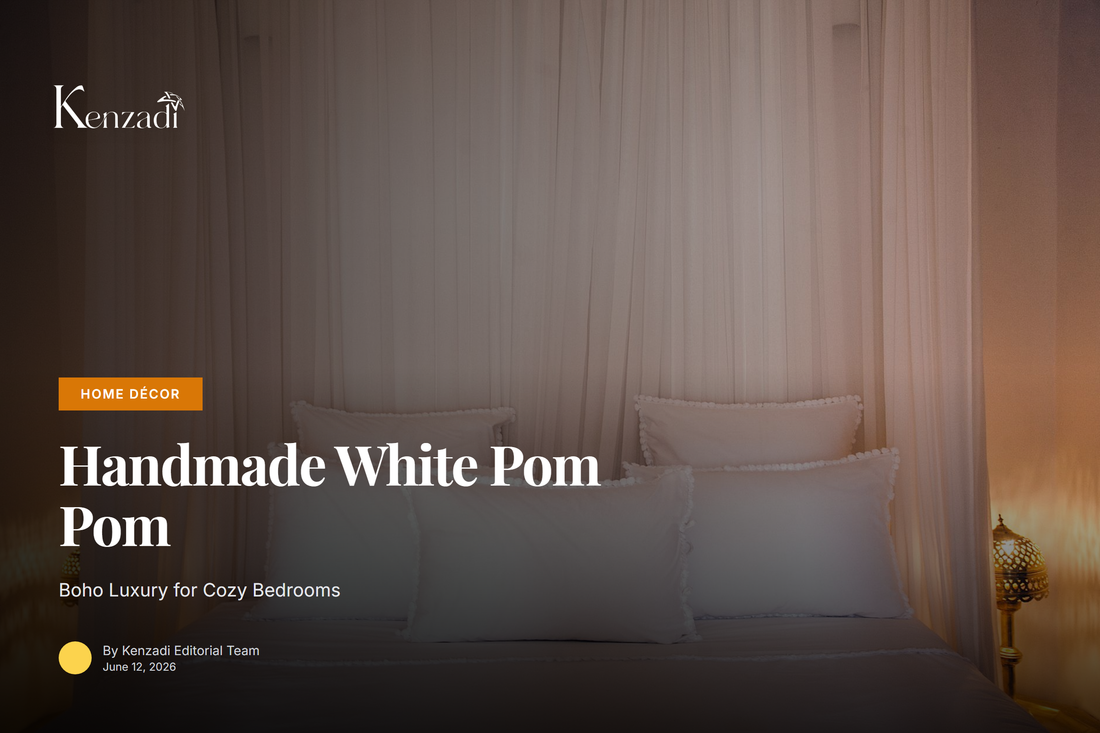 A white handmade pom pom blanket draped over a queen-size bed in a bright, boho-styled bedroom