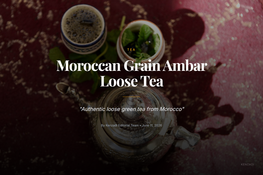 A glass of traditional Moroccan mint tea beside a metal teapot and fresh mint leaves