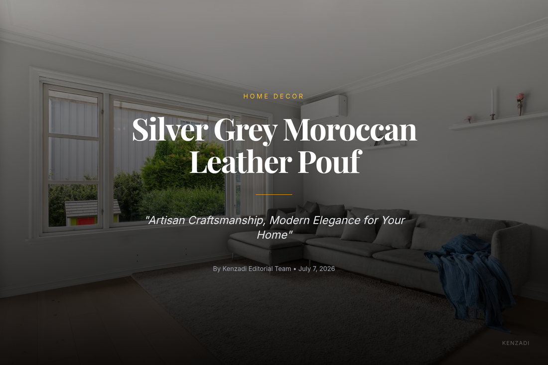 Round silver grey Moroccan leather pouf with subtle grey embroidery, placed on a light rug in a contemporary