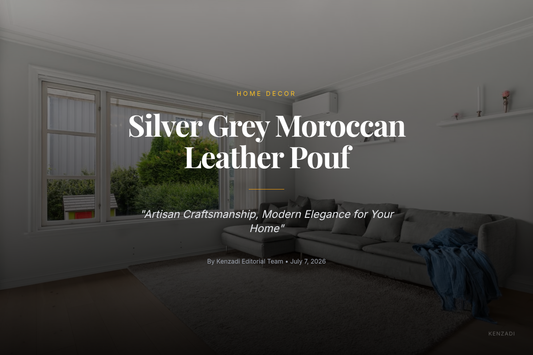 Round silver grey Moroccan leather pouf with subtle grey embroidery, placed on a light rug in a contemporary