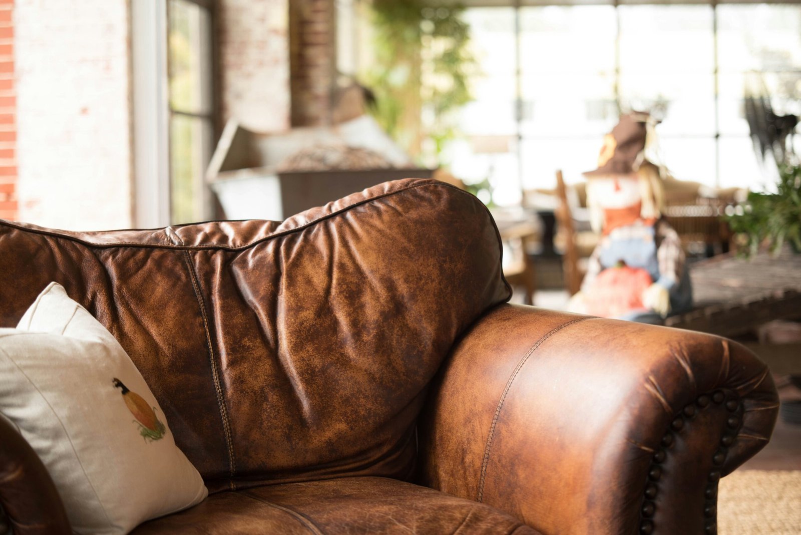 white throw pillow on brown leather armchair